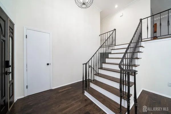 a view of entryway with wooden floor and stairs