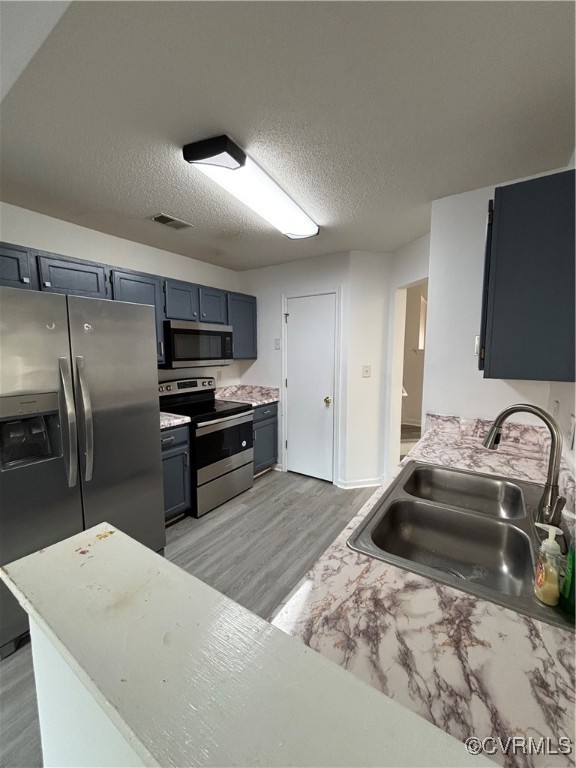 18 Bluesage Path Hampton, VA 23663 - Photo 10 of 28 Kitchen featuring range, a textured ceiling, sink,