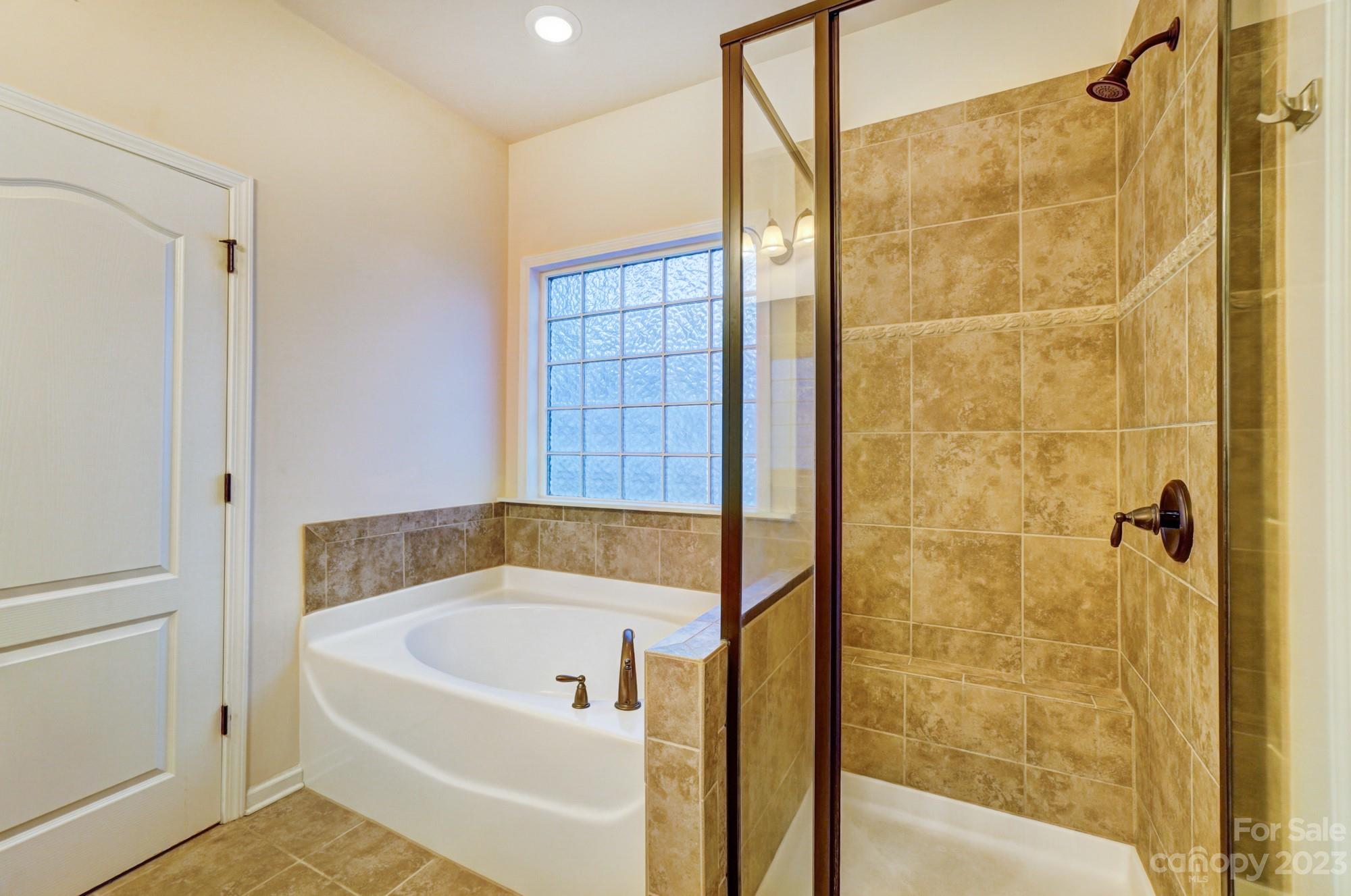 1726 Still River Way Fort Mill, SC 29708 - Photo 11 of 28 a bathroom with a bath tub and shower