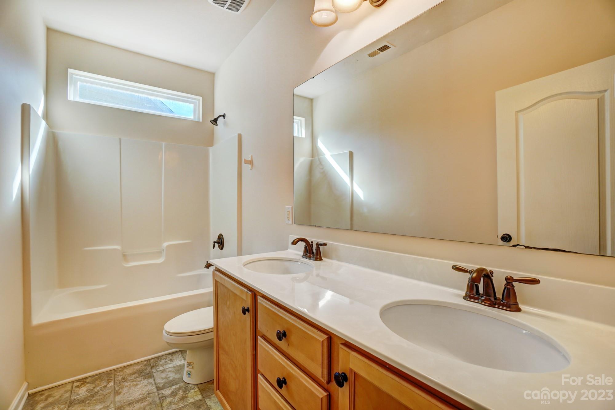 1726 Still River Way Fort Mill, SC 29708 - Photo 18 of 28 a bathroom with a granite countertop sink toilet and shower