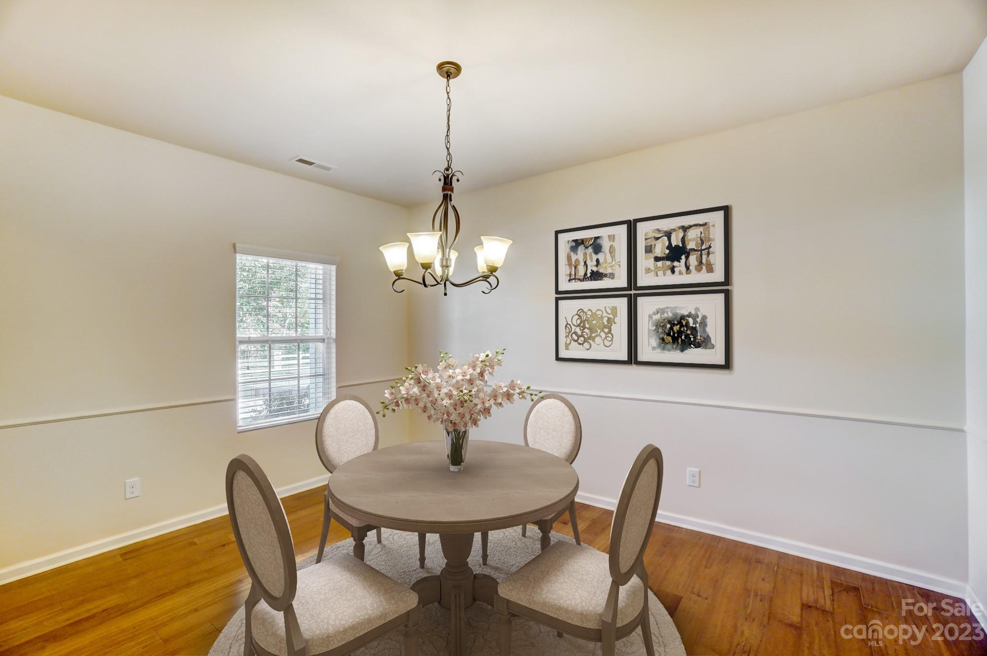 1726 Still River Way Fort Mill, SC 29708 - Photo 3 of 28 a view of a dining room with furniture wooden floor and chandelier