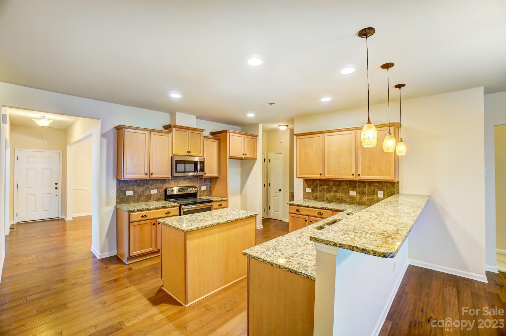 1726 Still River Way Fort Mill, SC 29708 - Photo 7 of 28 a kitchen with stainless steel appliances granite countertop a sink stove and refrigerator