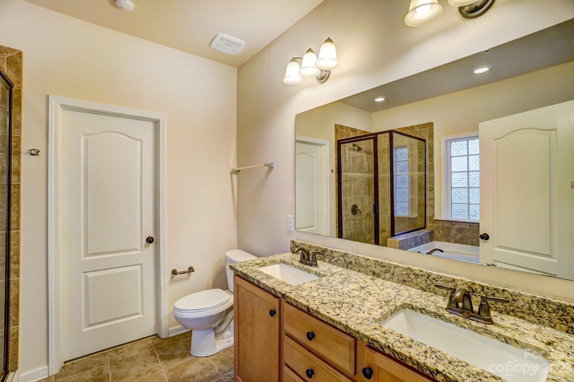 1726 Still River Way Fort Mill, SC 29708 - Photo 10 of 28 a bathroom with a granite countertop sink toilet and shower