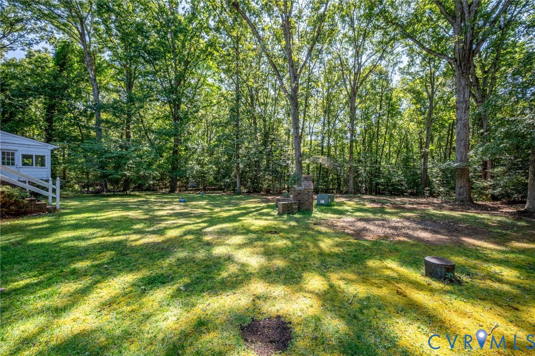 2409 Three Bridge Road Powhatan, VA 23139 - Photo 36 of 39 Expansive grassy backyard featuring mature trees,