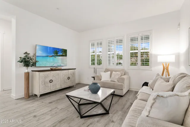 a kitchen with a stove a sink a dining table and chairs