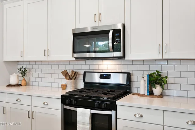 a utility room with wooden floor washer dryer and washer