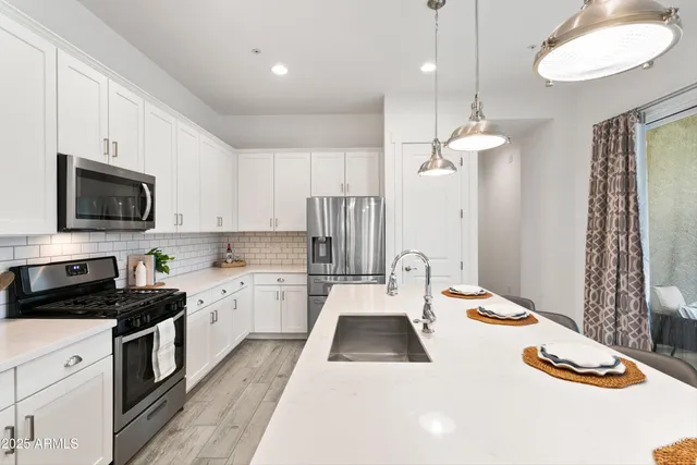 an aerial view of residential houses with outdoor space and lake view