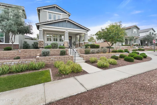 a view of a hallway with wooden floor and a potted plant