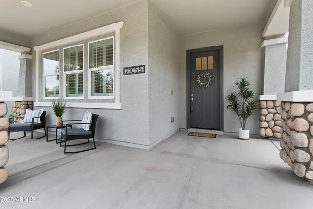 a living room with furniture a flat screen tv and a window