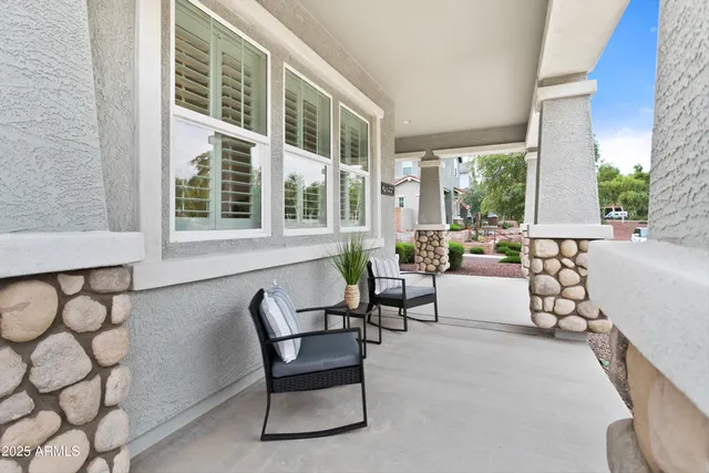 a living room with furniture a wooden floor and a chandelier