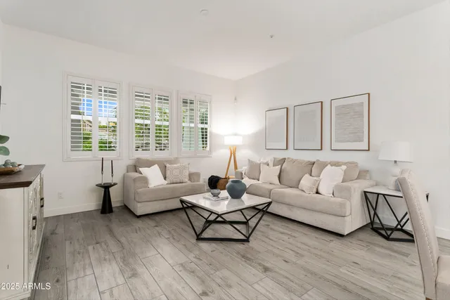 a kitchen with kitchen island a white counter top space a sink stainless steel appliances and cabinets