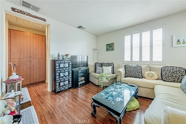a living room with furniture and wooden floor