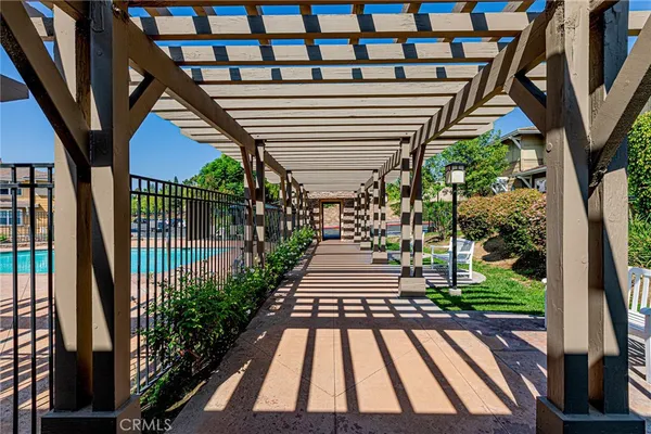 a view of a porch with a floor to ceiling windows with wooden fence