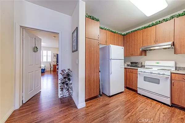 a kitchen with a refrigerator and a stove top oven