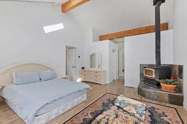 a bedroom with a large bed and a large window