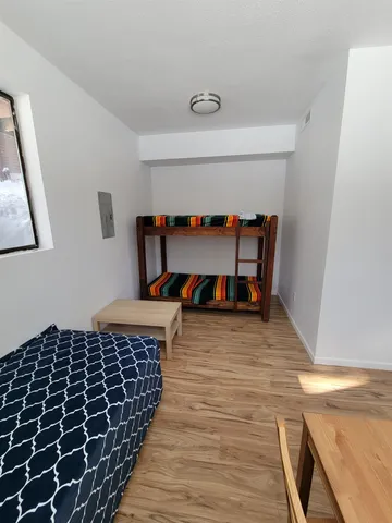 a front view of house with yard and trees around