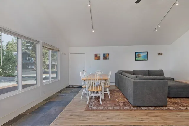 a dining room with furniture and wooden floor