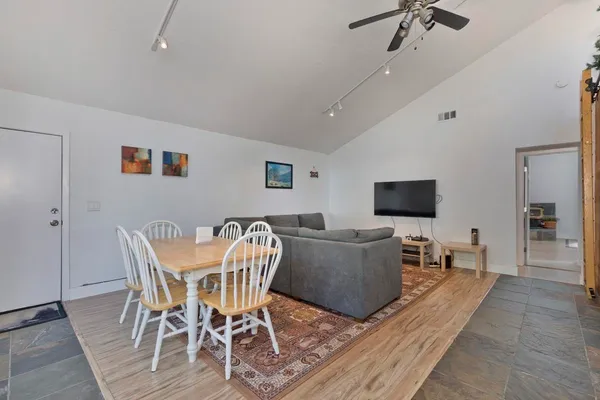 a living room with furniture and a wooden floor