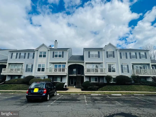 a car parked in front of a brick house