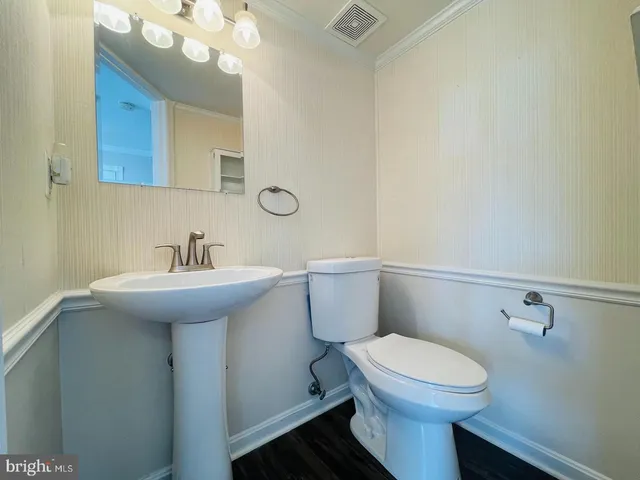 a bathroom with a sink a mirror and a toilet