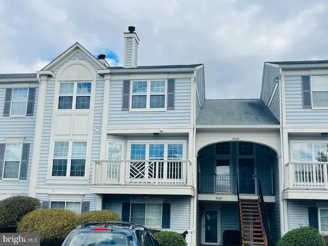 a front view of a residential apartment building with a yard