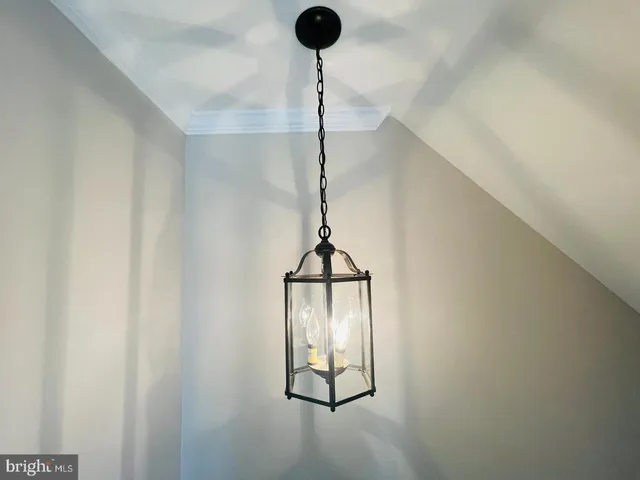 a view of a hallway with wooden floor and stairs