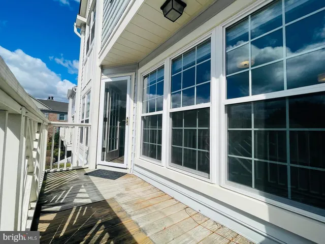 a view of a balcony with wooden fence