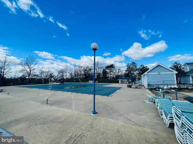 a kitchen with stainless steel appliances granite countertop a sink dishwasher a stove and a microwave oven with cabinets