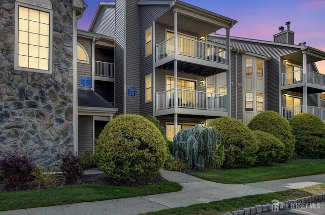 a view of a brick house with a yard