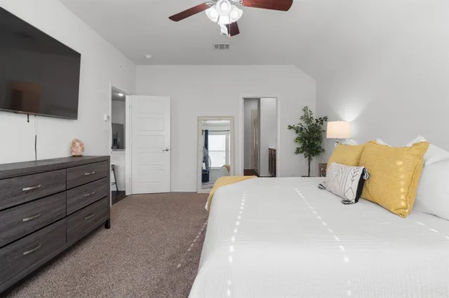 a bedroom with a bed and a flat screen tv