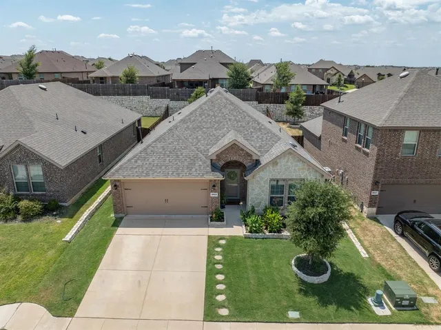 an aerial view of a house with yard swimming pool and outdoor seating