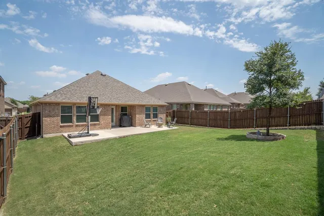a backyard of a house with table and chairs