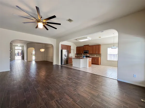 a view of empty room with wooden floor