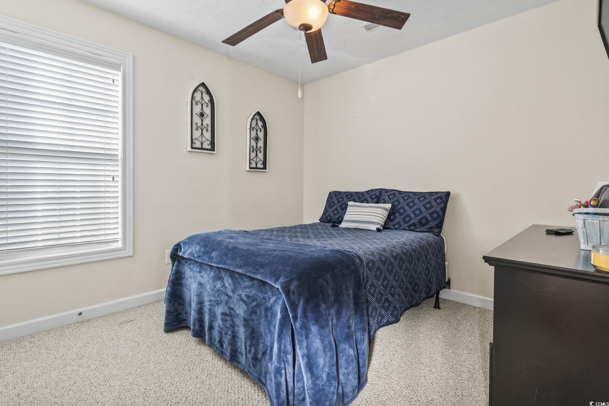 3141 Shorecrest Bay Drive Murrells Inlet, SC 29576 - Photo 19 of 30 Bedroom with light carpet and ceiling fan