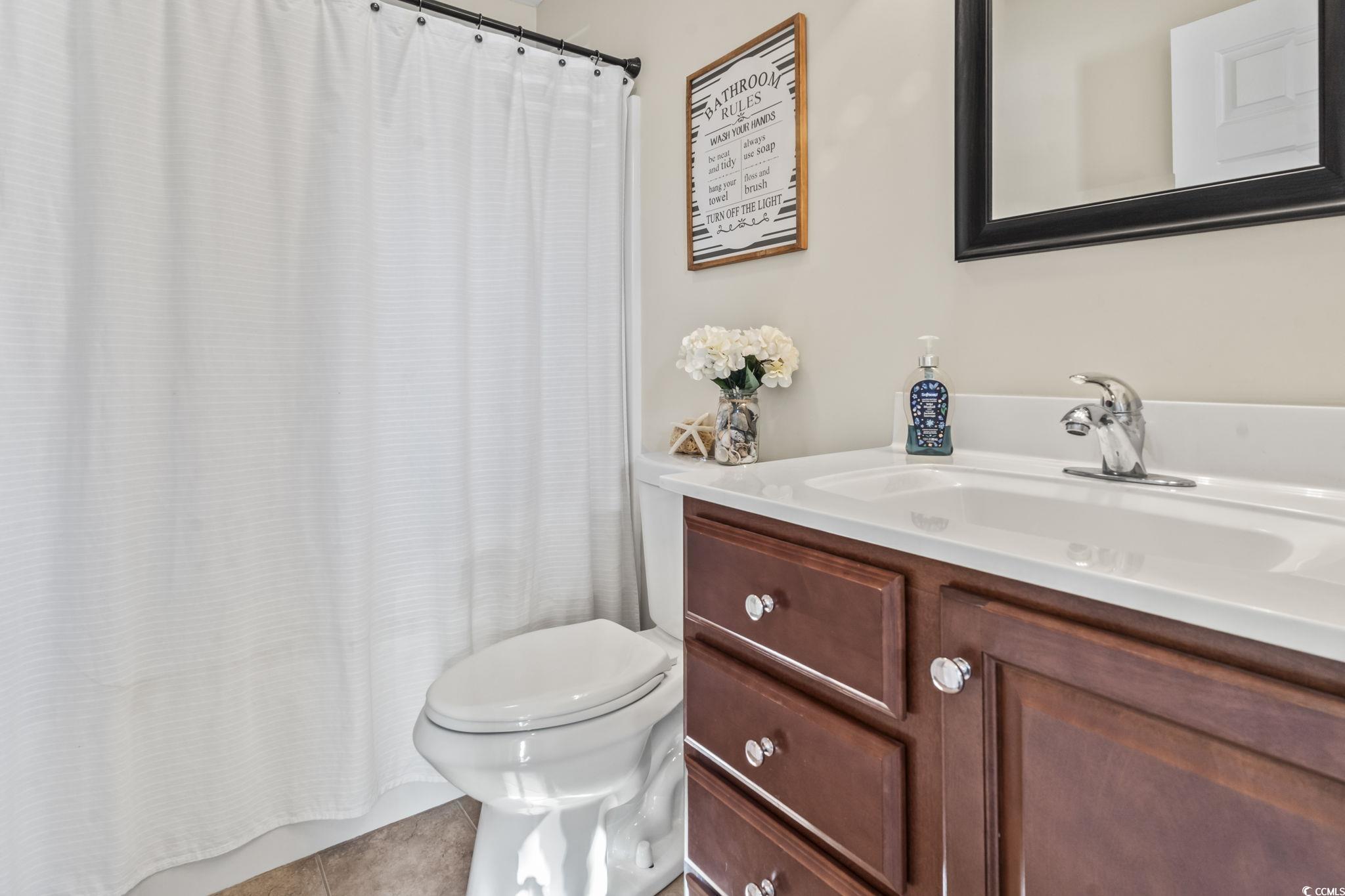 3141 Shorecrest Bay Drive Murrells Inlet, SC 29576 - Photo 22 of 30 Bathroom with vanity, toilet, and tile patterned f