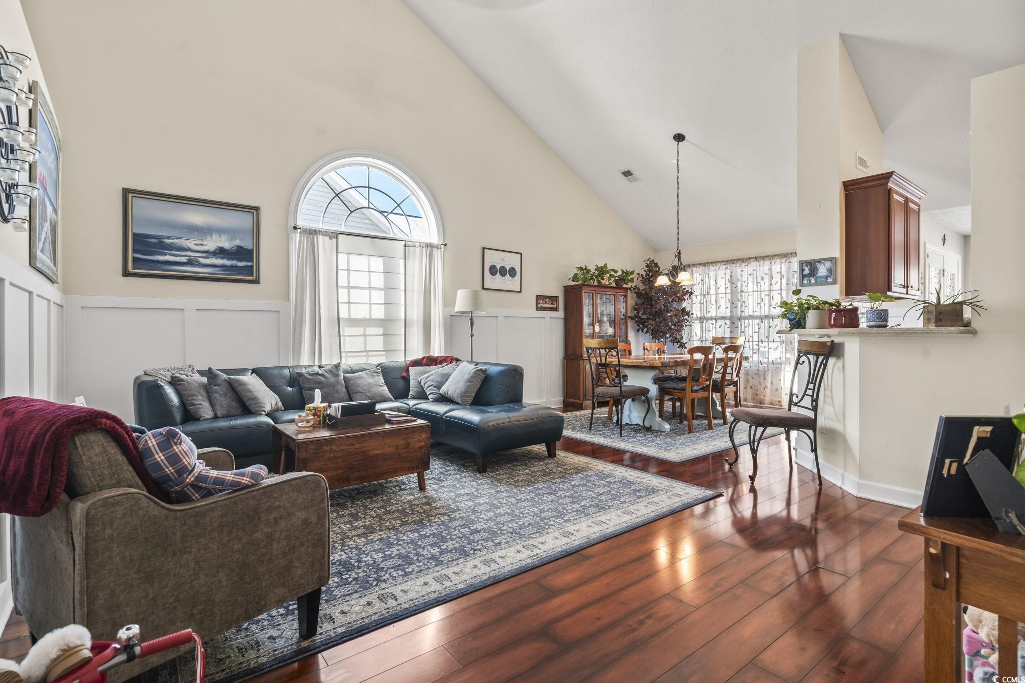 3141 Shorecrest Bay Drive Murrells Inlet, SC 29576 - Photo 5 of 30 Living room with a towering ceiling and dark hardw