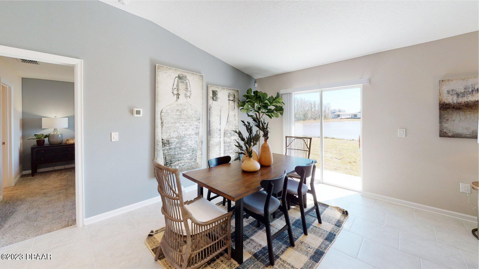 3981 Willowbrook Drive Edgewater, FL 32141 - Photo 4 of 12 a view of a dining room with furniture and a potted plant