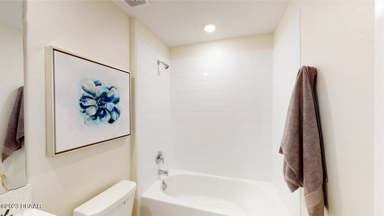3981 Willowbrook Drive Edgewater, FL 32141 - Photo 7 of 12 a bathroom with a bathtub and a toilet