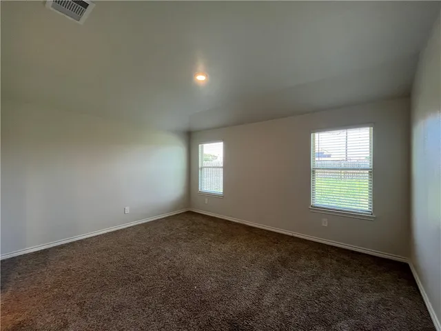 an empty room with a empty space and windows