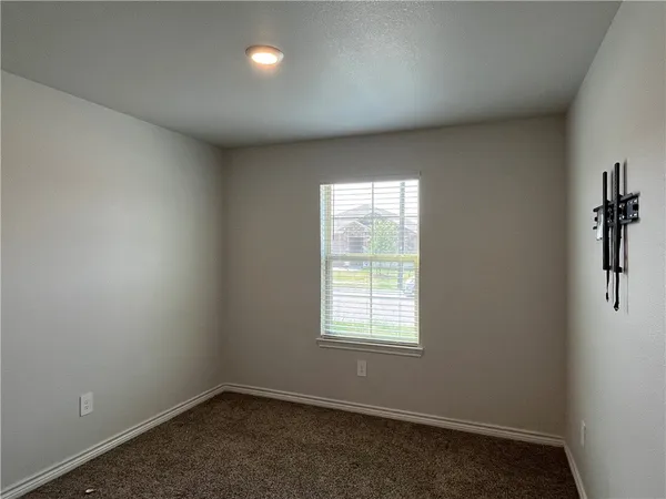 an empty room with a empty space and windows