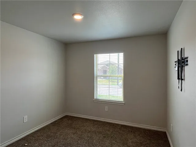 an empty room with a empty space and windows