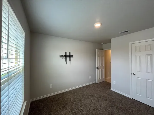 an empty room with a empty space and windows