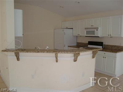 17397 Arizona Road Fort Myers, FL 33967 - Photo 4 of 4 a kitchen with appliances a sink and cabinets