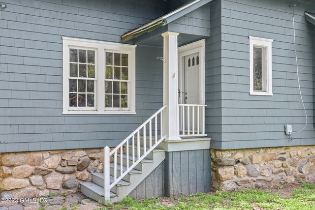 a view of a house with wooden fence