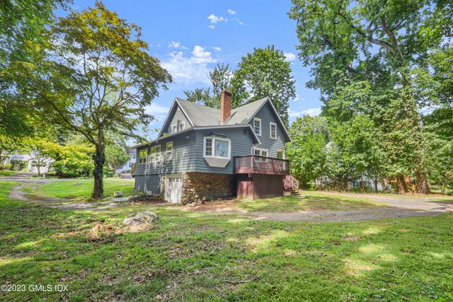 a front view of a house with a yard garage and outdoor seating