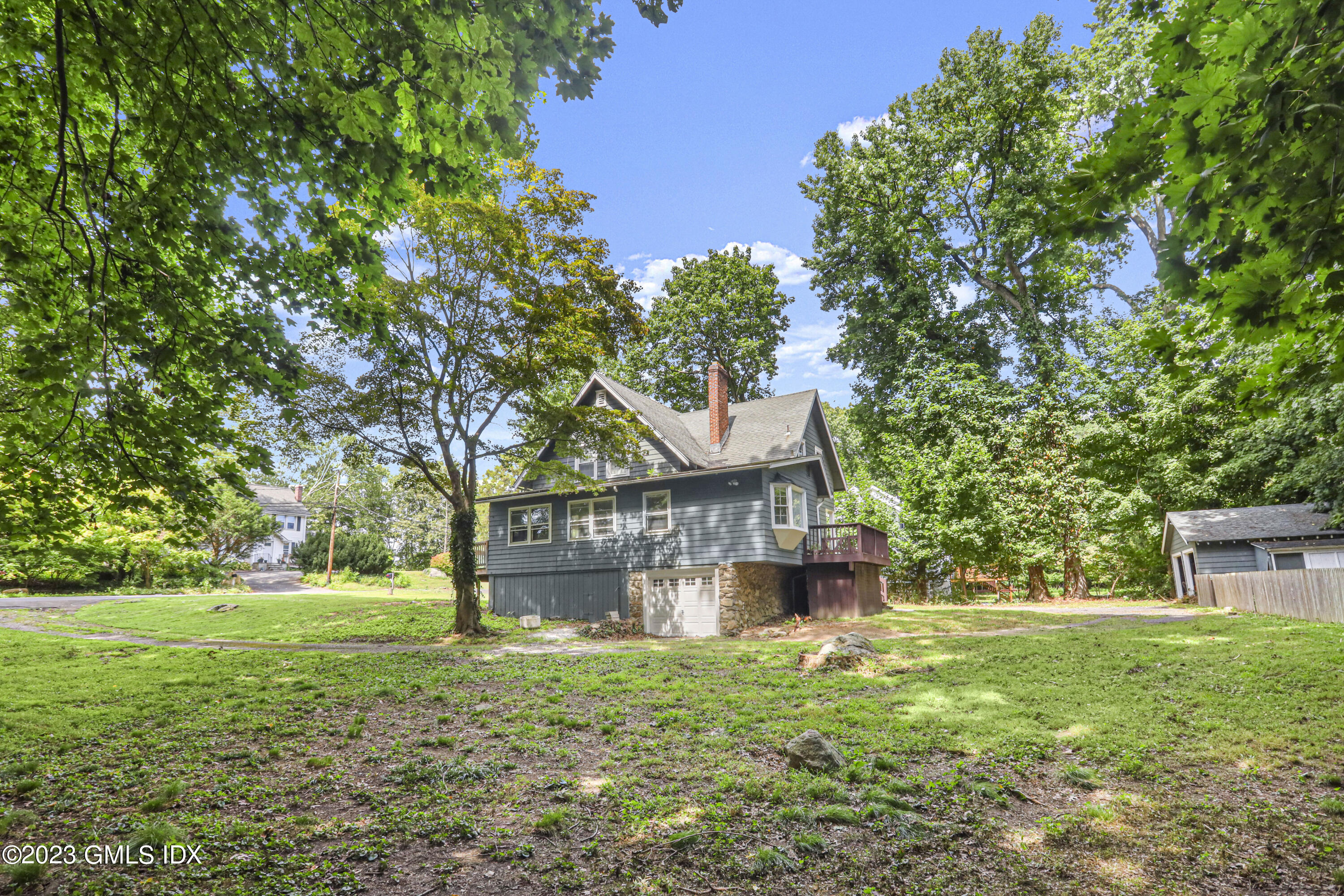 33 Breezemont Avenue Riverside, CT 06878 - Photo 19 of 31 a view of a house with a yard and a large tree