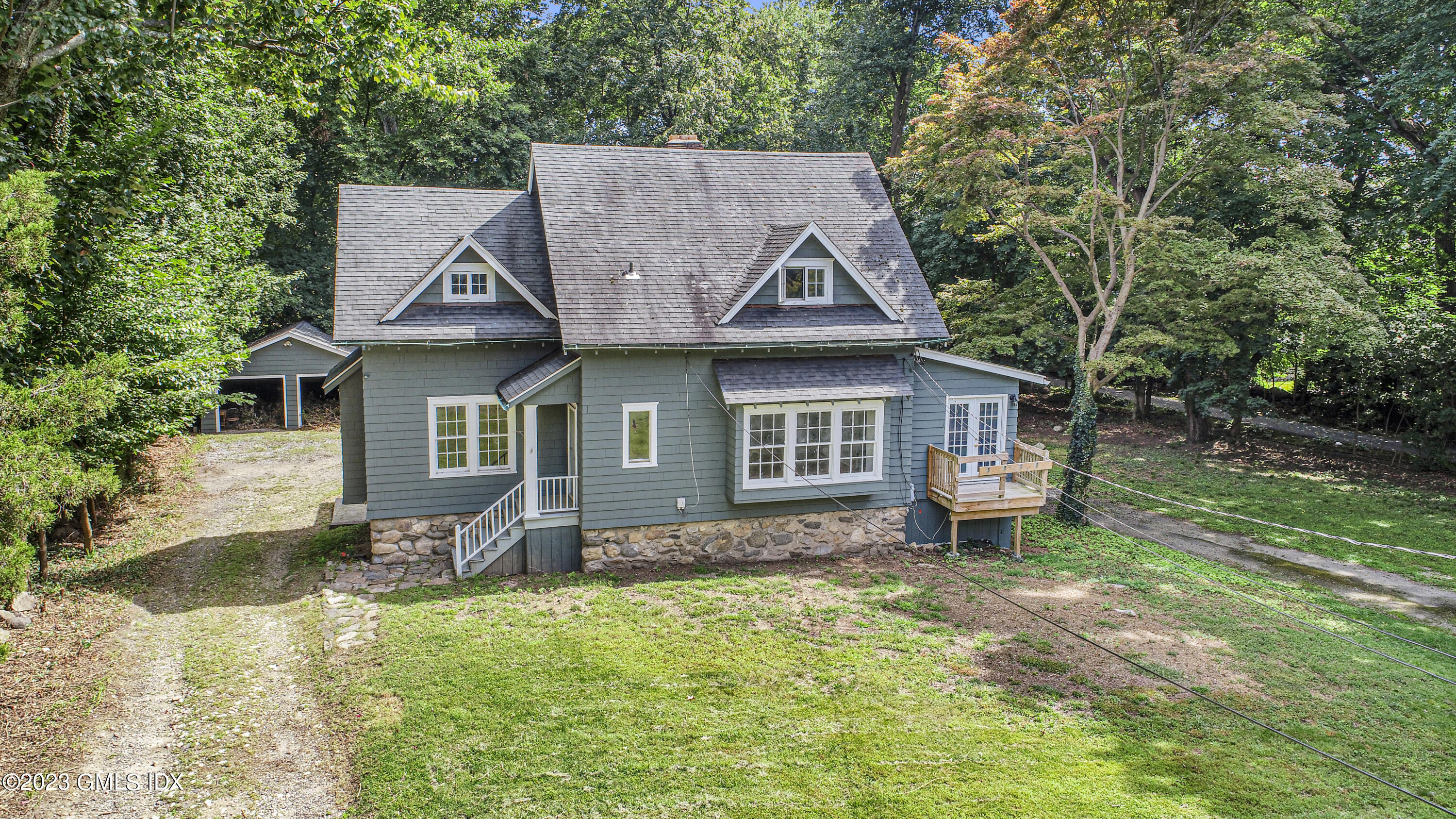 33 Breezemont Avenue Riverside, CT 06878 - Photo 2 of 31 a front view of a house with a garden and trees