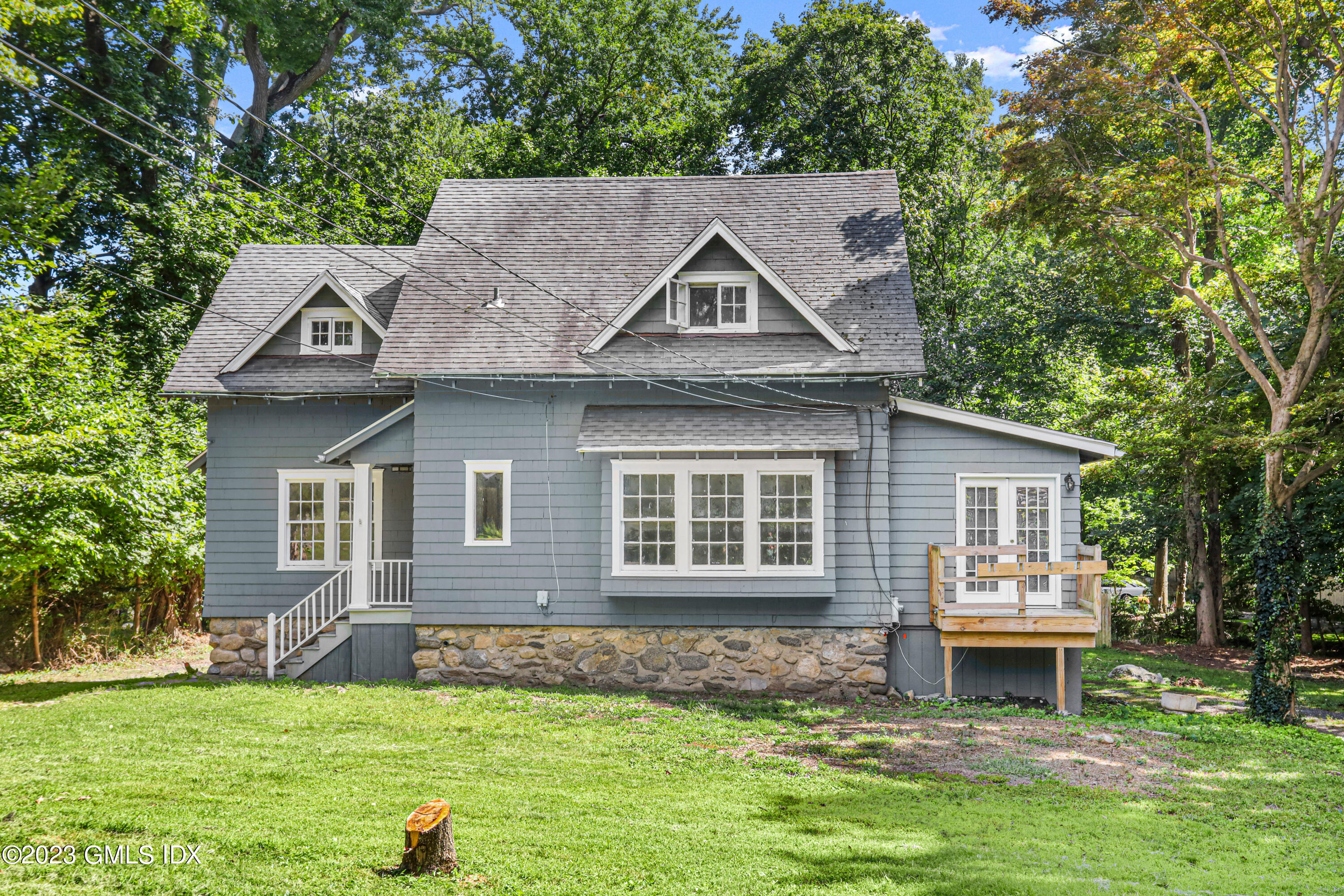 33 Breezemont Avenue Riverside, CT 06878 - Photo 22 of 31 a front view of a house with a garden and yard