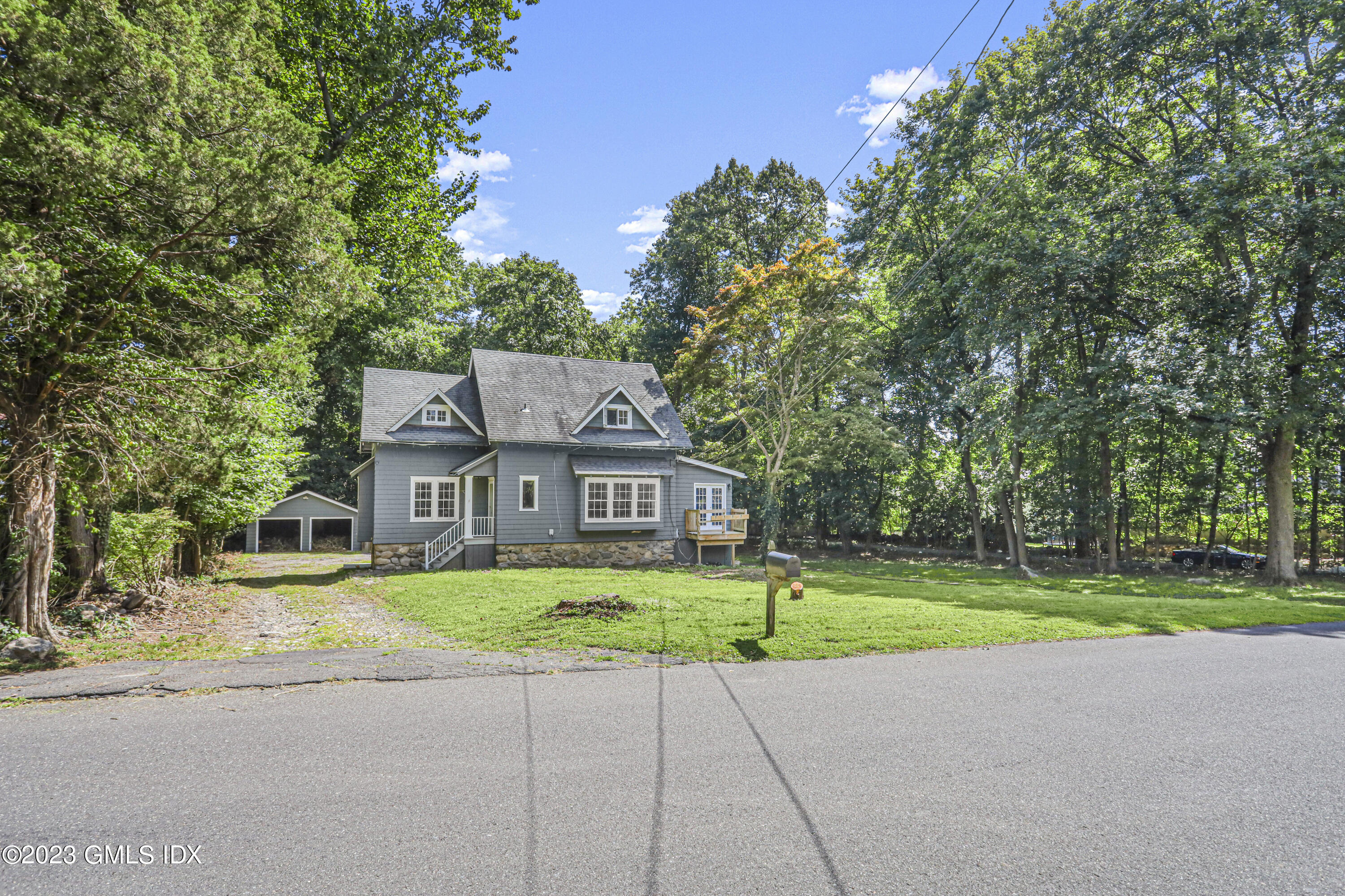 33 Breezemont Avenue Riverside, CT 06878 - Photo 25 of 31 a front view of a house with a yard and trees