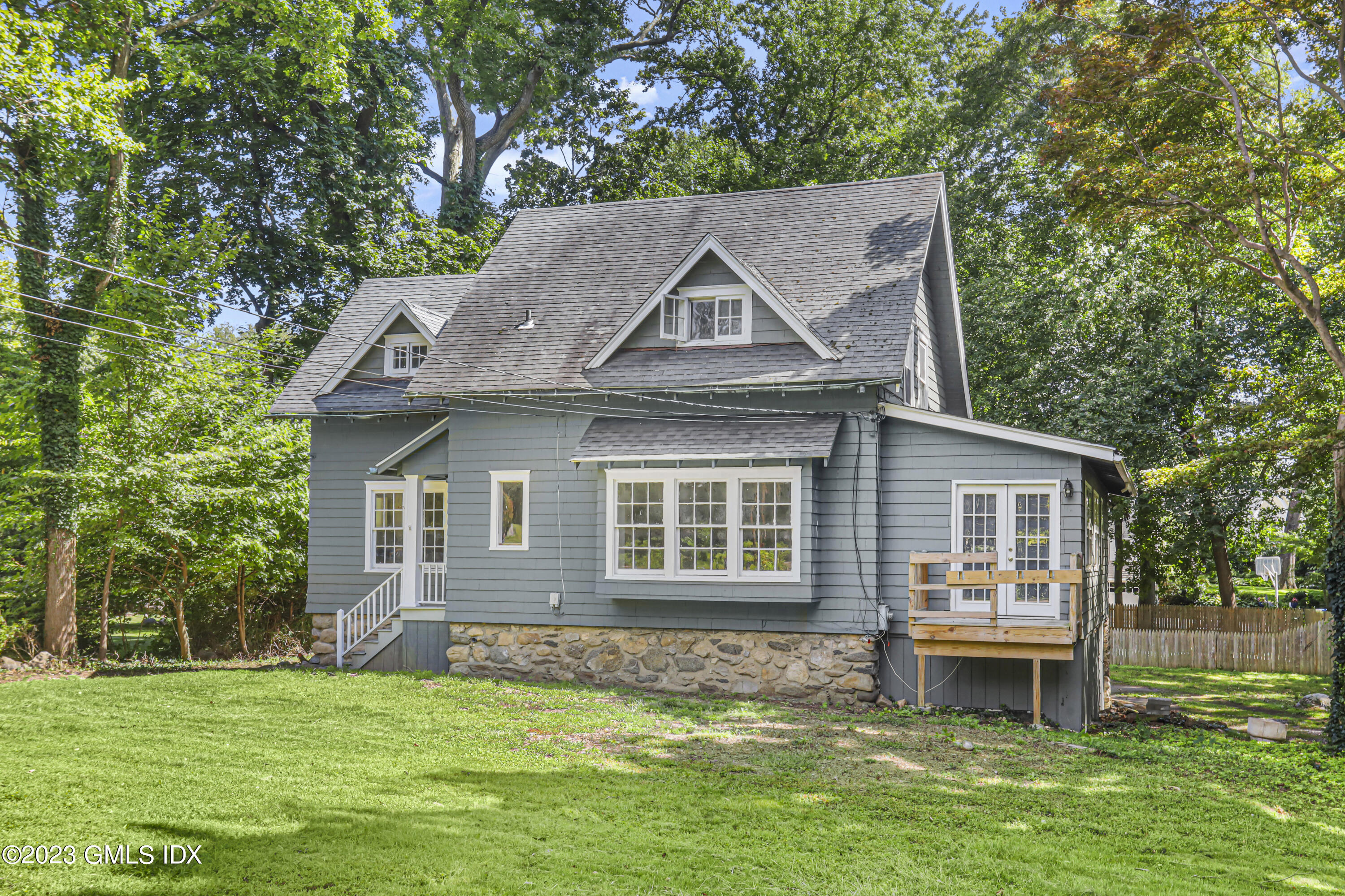 33 Breezemont Avenue Riverside, CT 06878 - Photo 3 of 31 a front view of a house with a garden